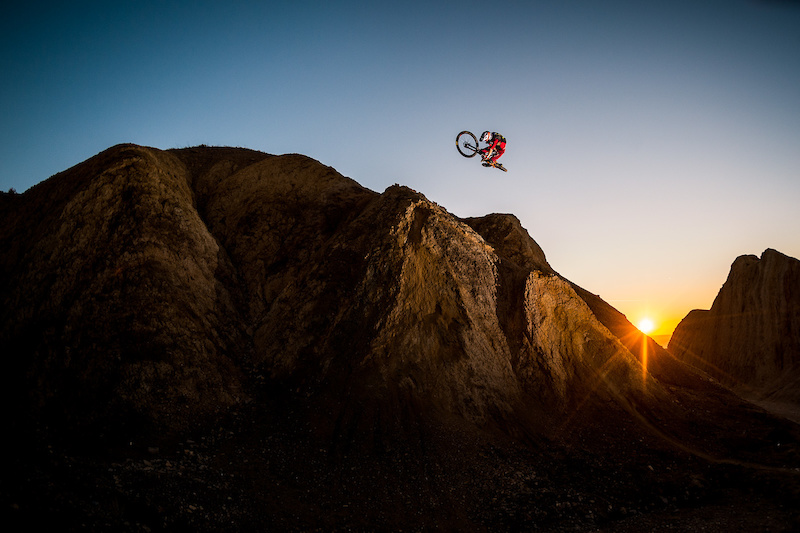 Kirt Voreis performs a table on his Niner Bikes RIP 9 RDO on a giant natural quarter pipe in the California desert.