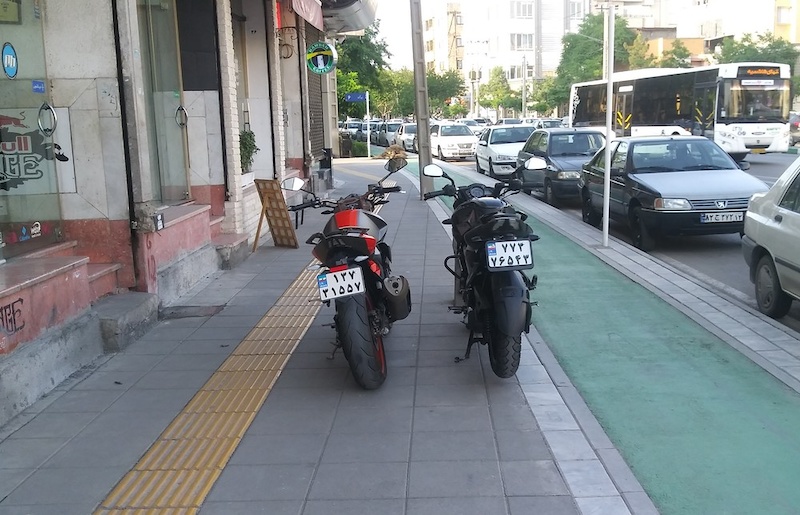 motorbikes in sidewalk while out of bike line