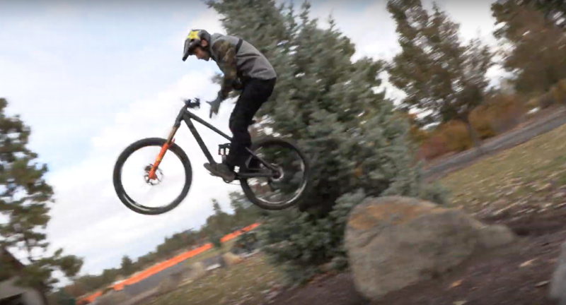 barspin off a rock while the kids play at the park