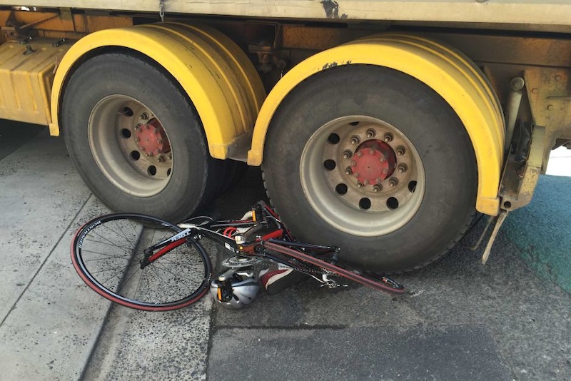 A bicycle is trapped under the back wheels of a truck after an accident in Hobart

ref:ABC