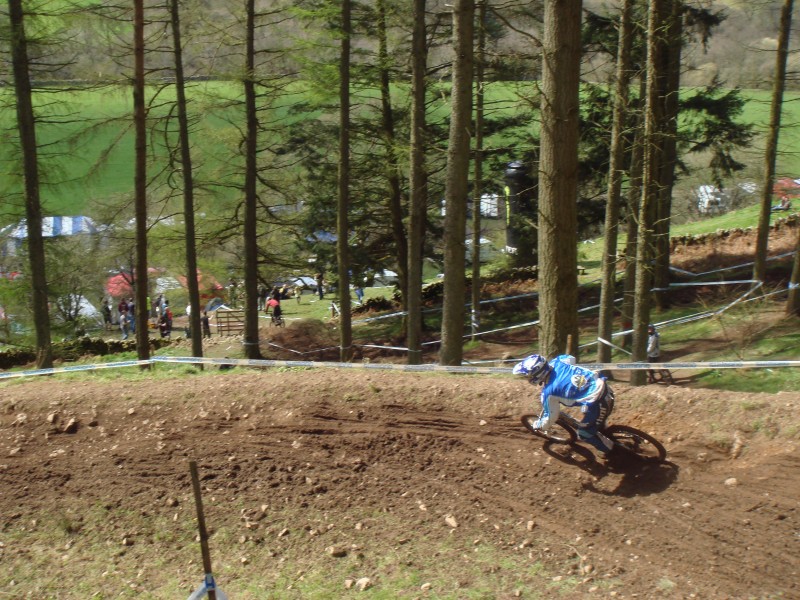 an unknown rider flat out around the berm at the bottom