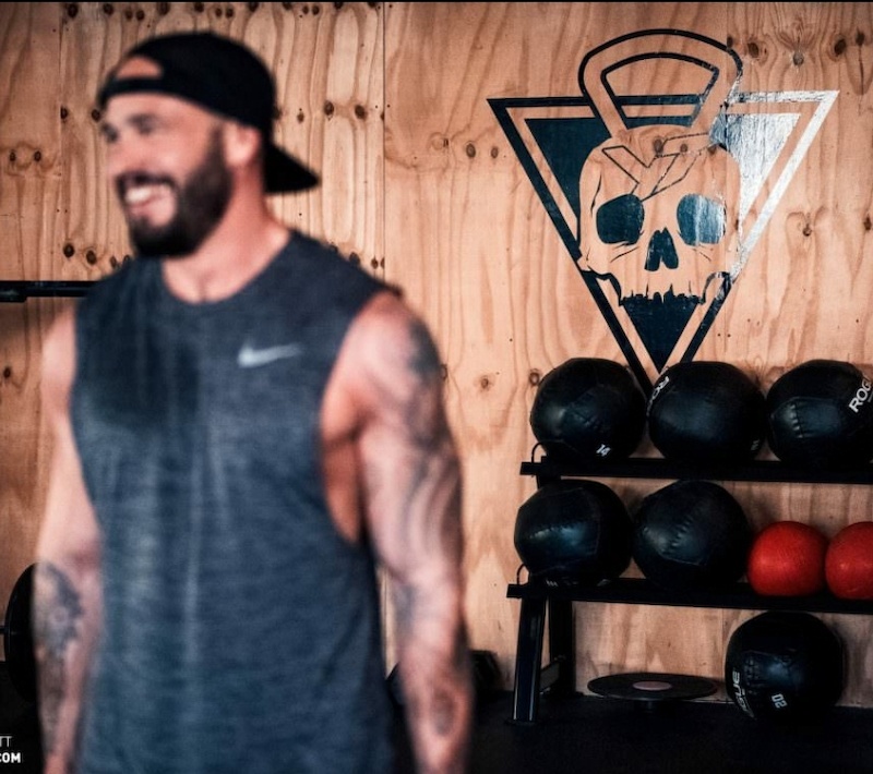 German YT owner smiling in front of a punisher skull image while showing off his Nordic tatts with a wife beater T shirt. Can t help but wonder if he might be a little insecure about his masculinity.