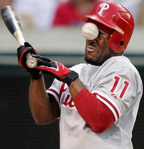 a guy having a baseball to the face...