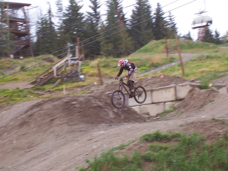 Jumping the last jump in the Biker X Course at Whistler.
