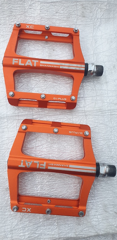 orange metal bike pedals