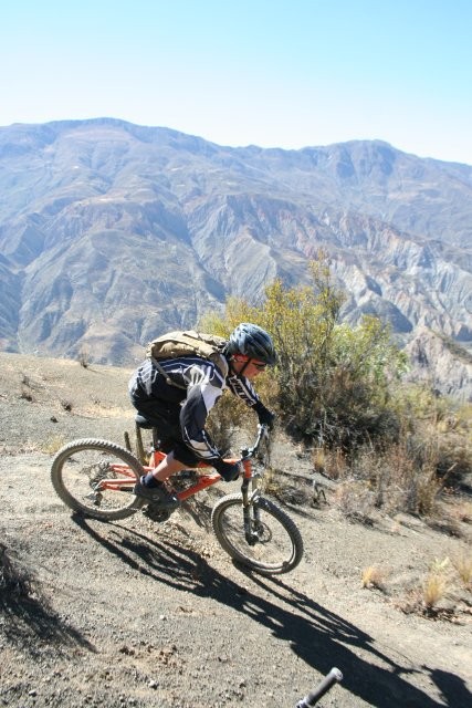 Ripping around a corner and cactus with the Andes in the background.
