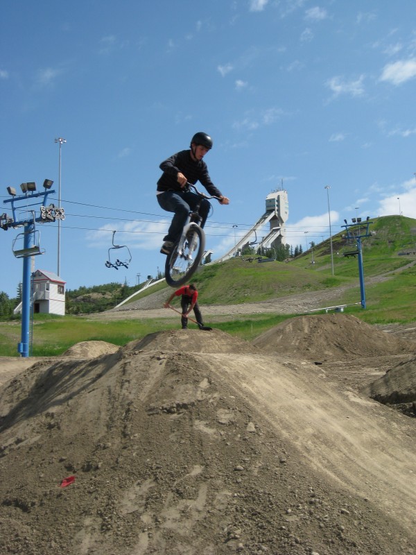 COP-Dirt Jump park area-looks like he's jibbing the worker in the back ground.