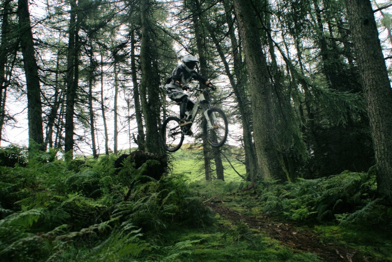 Me riding at staveley, doing a step down / drop on a beautiful British summers day (Raining slightly)