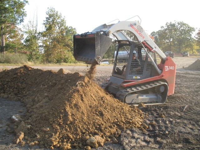 Me placing dirt for the roller line burm.