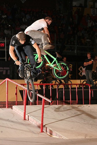 aaron doing a whip over a rail and some other guy nose picking