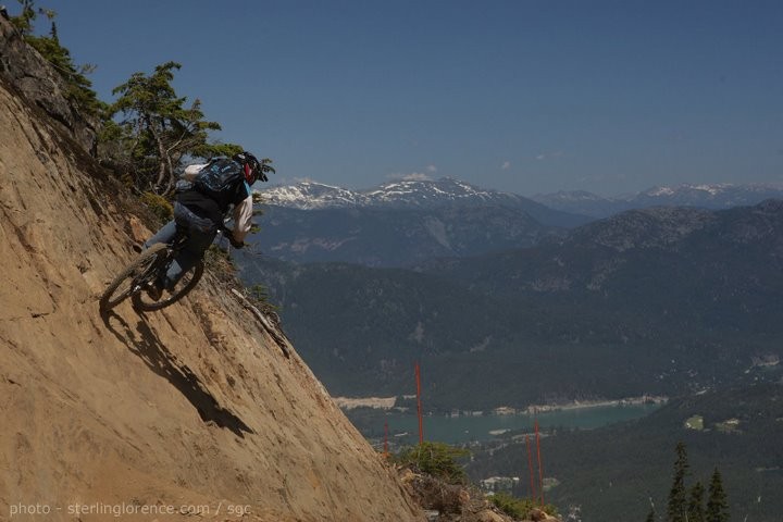 bryce nelson doing the natural wallride in whistler with an awesome view of the lake