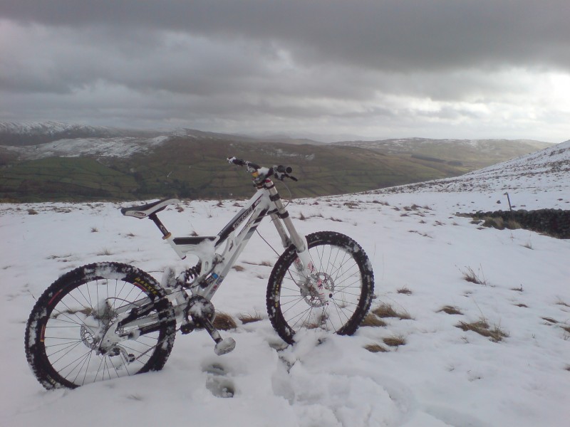 My bike covered in snow looking over the lakes.