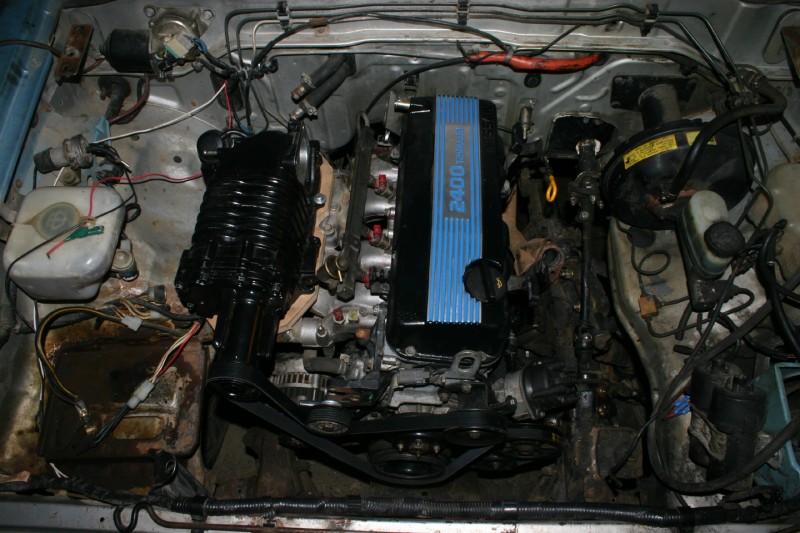 A shot of my new motor.  It's a nissan ka24e sohc 2.4L motor with an eaton m62 supercharger from an nissan xterra.

Should get me to the top of the hill a little faster.