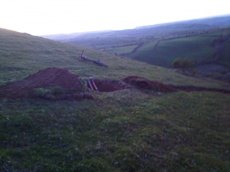 shitty photos of new jump.its not quite finished yet.its about an 8 foot gap with a slight hip to the right.