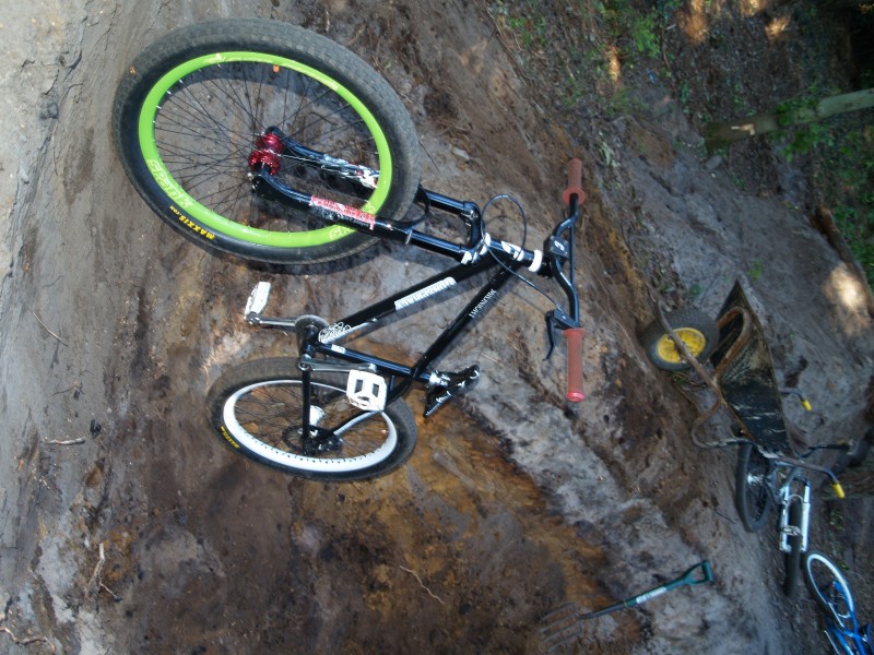 My bike in a pit. *need to get my other ns hub and green spank rim, and spray my forks and frame white*