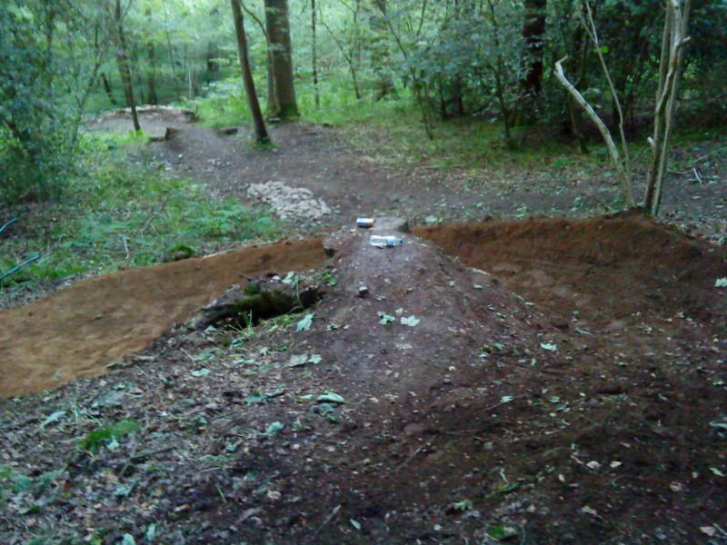 Log drop with new berm, showing kicker and huge berm in the background.