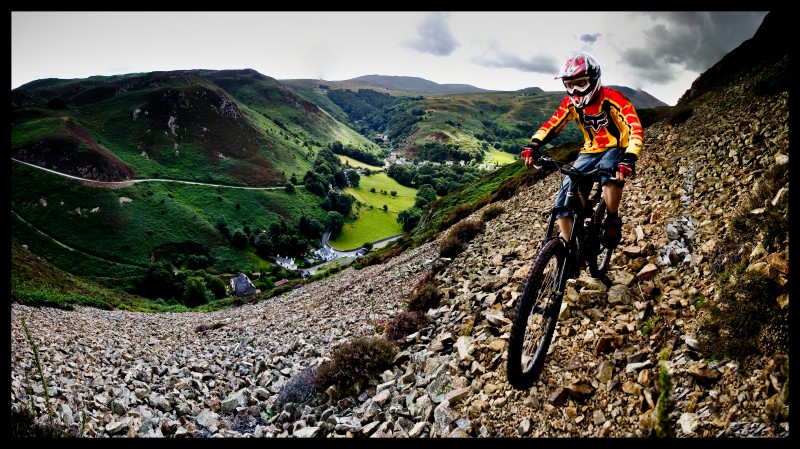 Rob riding a very narrow path over some steep loose shale and rocks high up in the Conwy mountain range - Cubed Square Photography - Laurence CE