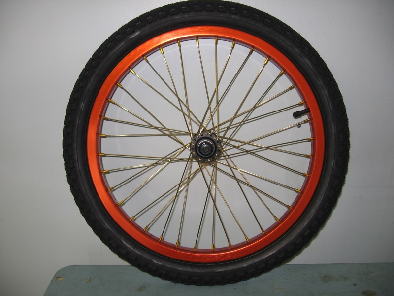 custom front wheel for the P.W. moto: hub wtp PI, ion plated gold spokes, G-sport taper hex nipples gold, proper rim orange