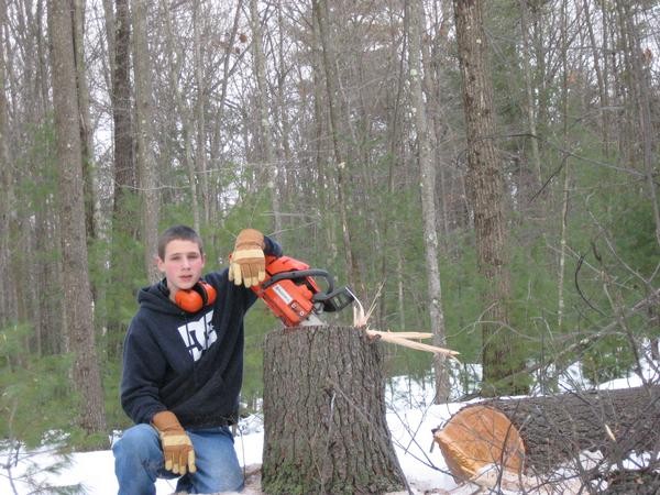 me at 13 y/o. First tree I ever felled, while on my own in the woods. About 20" in diameter and over 100' tall. Landowner said I could cut it down.