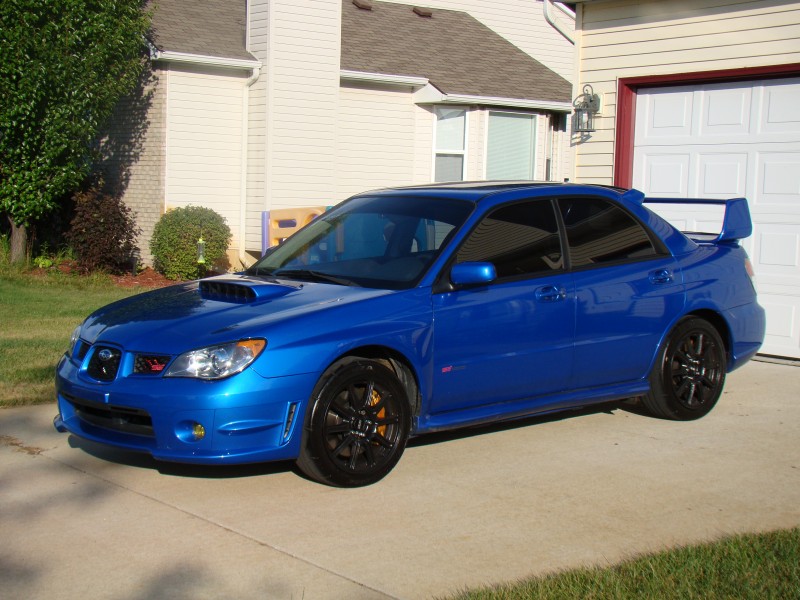 My 06 STi after tint and painting the wheels