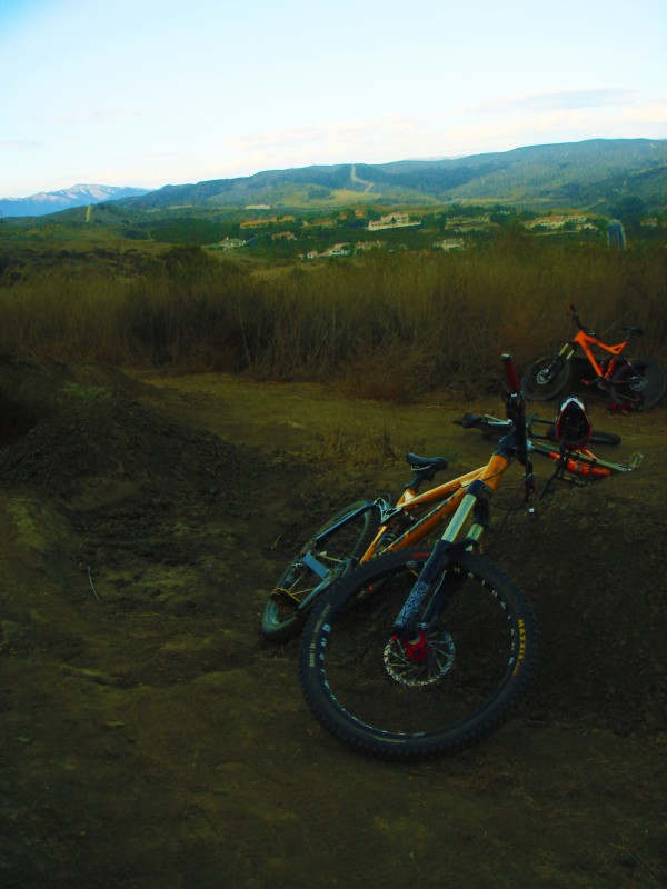 Shot of the bikes laying around near some jumps.