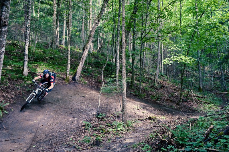 Exiting the final berm on Sidewinder in Vermont's Kingdom Trails.