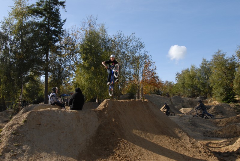 lots of people jumping over mounds of dirt
