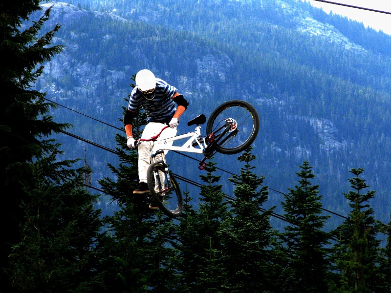 Tailwhiping the first jump of the course in Crankworx