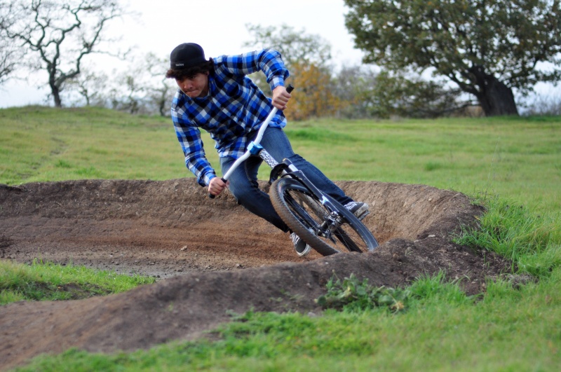 Funn rider Kai railing a berm with his new Flat Out bars and Rippa stem