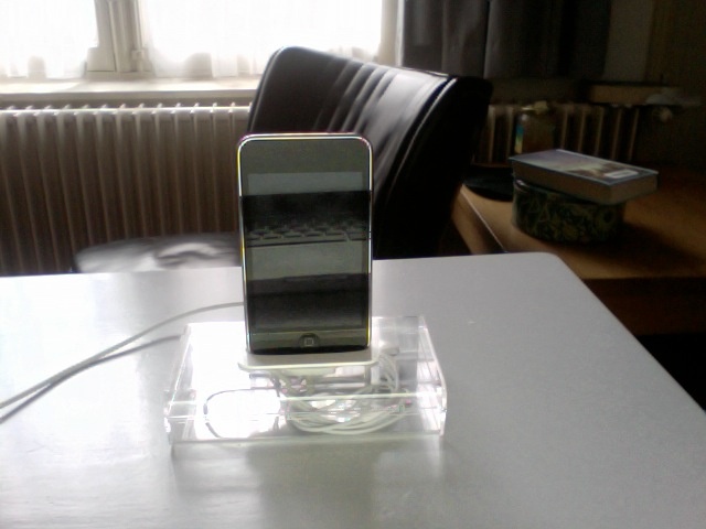 Home-made ipod stand. Made from Jewel-Case that contained the ipod. And the adapter that came with the ipod.