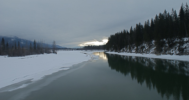 Kicking Horse River with the sun just barely coming through clouds.