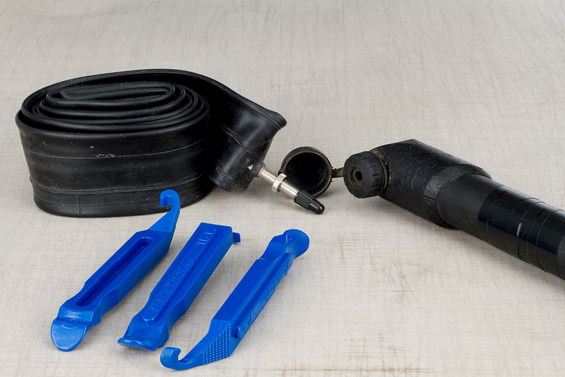 Tire levers, pump, and a new tube ready for action
