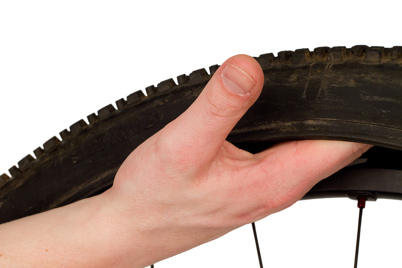 Use your hand to check the inside of the tire for foreign objects - be careful!