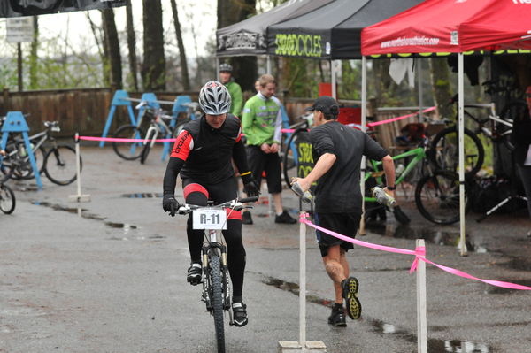 Transition area handoff between Chris Price (runner) and myself, about to give' 'er on the bike portion of the race.