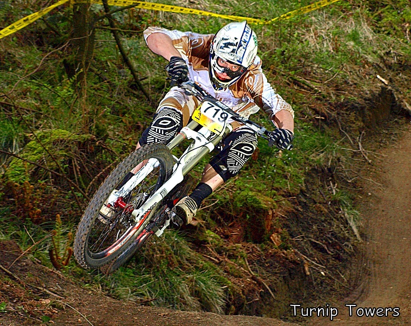 Pearce Cycles held two races at Bringewood this year. For the second race they used a new section of track which I hadn't photographed before, but I managed to find one spot where a small jump led to a big sweeping corner and looked really good on camera. I got quite a few pics of riders whipping the jump, but I like this one of Col Williams just for the look of total concentration, I think facial expression can make a big difference to a good photo.