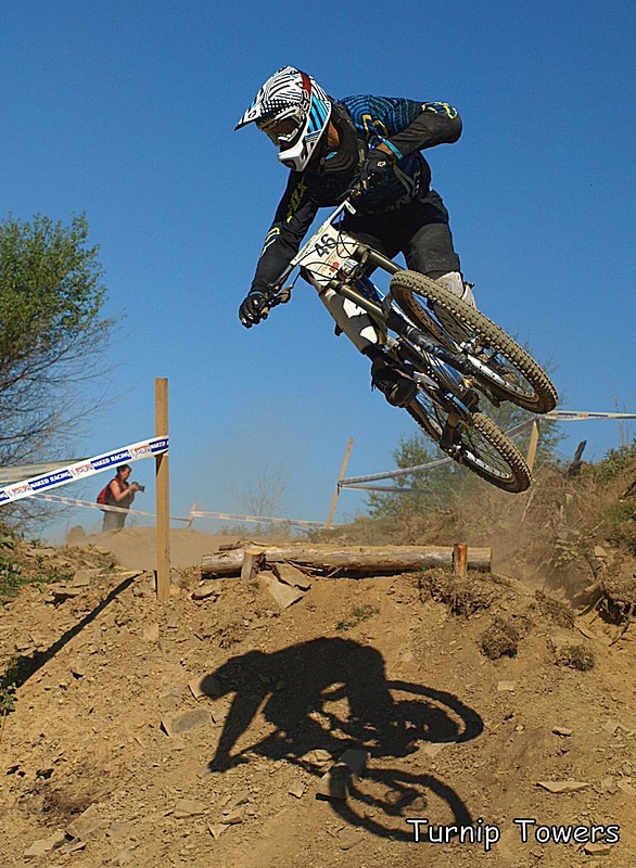 This jump near the top at Caersws is always good to photograph, as it's a step-down followed by a big right-hand berm. I like this shot, as Leon Rosser can always be relied on to style it up for the camera, and you get the impression that the bike is trying to go one way while the rider is trying to go the other, which pretty well sums up that jump. I also like the shadow on the track as it balances the shot nicely.