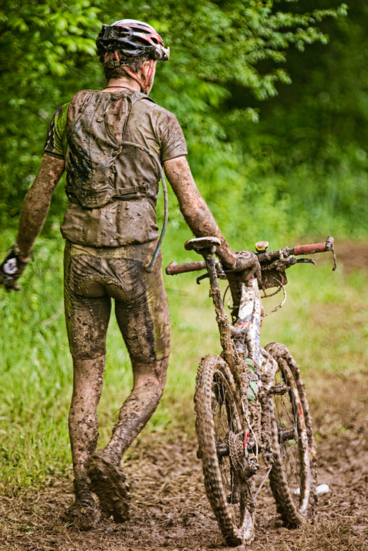 Race winner Jeremiah Bishop pushes his bike though the mud at Dirt, Sweat, and Gears, 2009.
