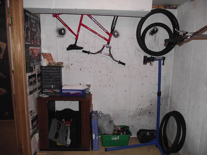 The back wall with my workstand, my snowbike hanging, and a cabinate for so power tools and fasteners and small parts compartment on top.