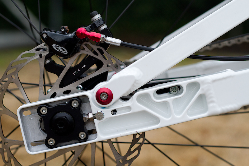 An adjustable wheelbase lets you fine tune the handling and tension the chain. The rear cog, drive chain, and disc rotor all stay in place when you remove the hub from the swing arm - pretty cool!