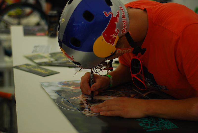 Martin Soderstrom signing posters at NS Bikes booth during Eurobike