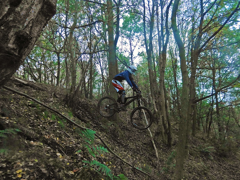 Riding in some local woods. Doing a drop...
