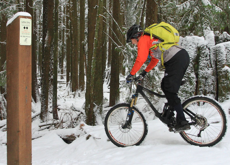 <span style='font-size:17px'>The Tracer 12 carries enough spare clothes for snowy rides</span><br><br>Accessing the pack during rides was easy, so long as I remembered which compartment I put whatever it was that I needed. I never felt lacking for space, even in cold weather riding when I would take extra gloves, jersey and extra jackets in case it got colder or rained. Getting to the water compartment required you to unhook the helmet carry to completely unzip, but you can access the inner compartment with the helmet carry hooks hooked. The Cordura-type material picks up dirt quite easily or is more noticeable on the bright colored pack. I spent some time in the rain while wearing the Tracer to see if it would absorb water, but it shed H2o quite well and didn't get any wetter than other packs would have in similar conditions. In other words, you shouldn't find yourself waterlogged when putting in the miles on B.C.'s