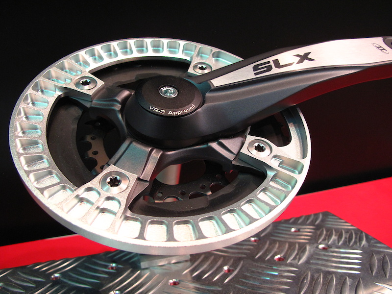 German company Syntace was showing off their new bash guard, the Grinder 36. It certainly looks to be one of the more intricate chain ring guards around, with CNC'd ribs and reliefs around it's entire circumference. Total weight is just 72 grams.