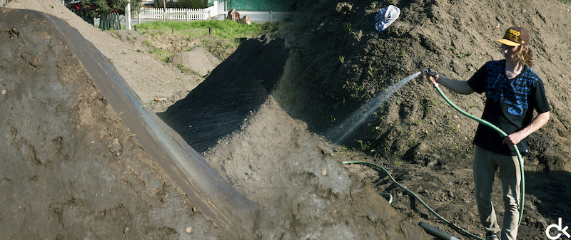 Even though it has been wet lately, a bit of water makes the work much easier. Guy giving the dirt a drink.