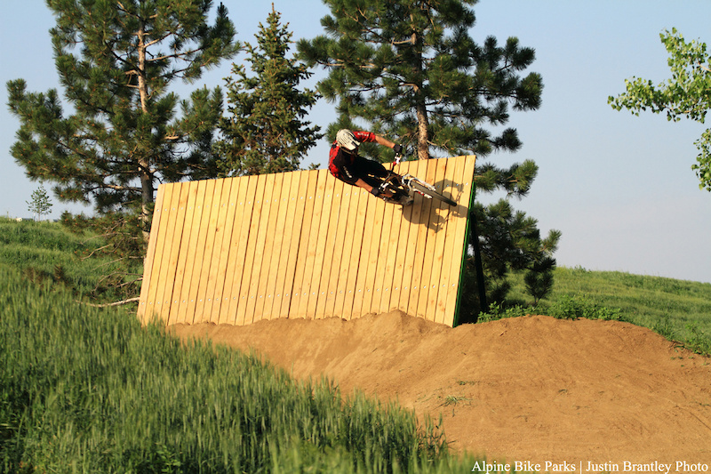 Riding the wallride at the end of the dirt jump line 