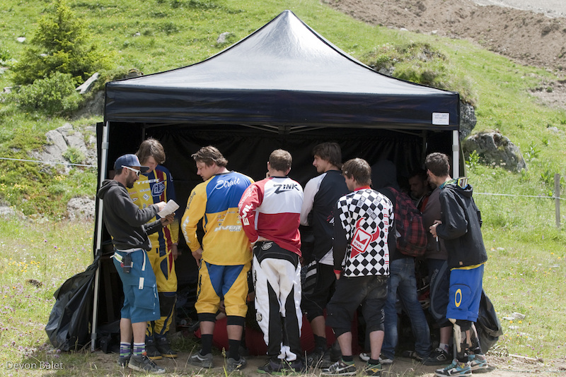 Pro riders watching their fellow competitors from the top.