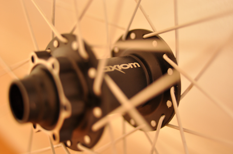Black Sun Single Track laced to Axiom 20mm sealed bearing hub with white powder coated spokes. 36 hole. For sale.