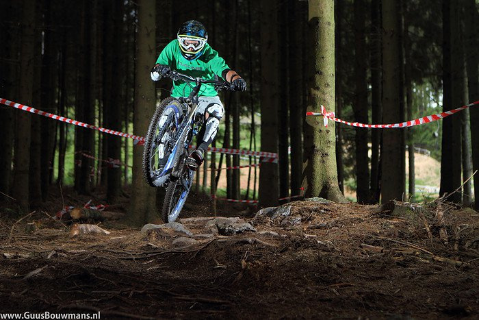 This is a photograph of Michel riding the technical root section of the Malmédy DH track