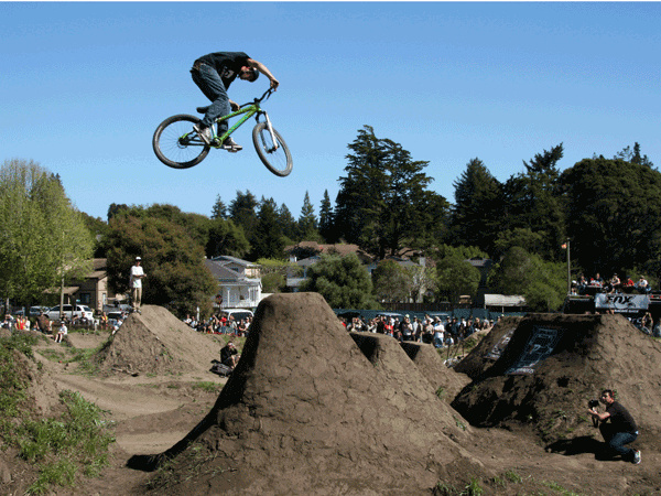 Photo by Karen Kefauver. The Aptos Post Office Jumps have been the training grounds for a number of world-class dirt jumpers. This summer 2012,  we bid farewell to these beloved jumps as the land they stand on is slated for construction. On a positive note, MBoSC is contributing $16,000 – raised at the 2011 SCMBF – toward a permanent Aptos Bike Park. Help us pay one last big tribute to these historic jumps by spectating, volunteering, or demo’ing a DJ bike!