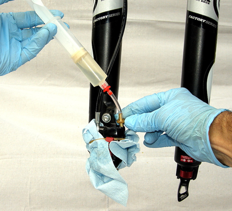 Remove plug and insert syringe fitting